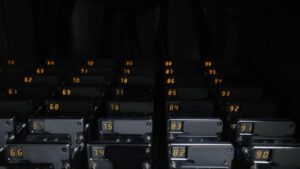 Rows of numbered battery cell test channels in an automated lab